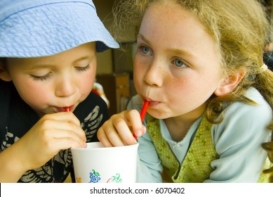 boy and girl sharing a drink