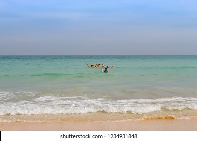 A Boy And A Girl Standing In A Sea Of ​​hands Photographed  At Cabana Beach In Chumphon ,Thailand. January 21, 2018.