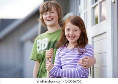 Boy And Girl Standing Together At Entrance Of Camping Houses