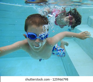 Boy And Girl Swimming Underwater