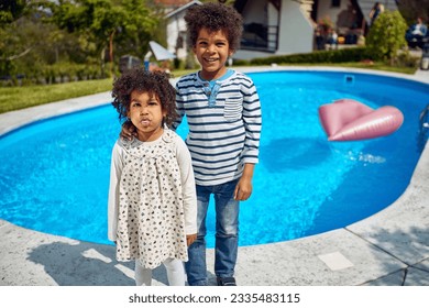  boy and girl take center stage, radiating happiness. The girl, with a mischievous grin, playfully sticks out her tongue, adding a touch of spontaneity to the moment.  - Powered by Shutterstock