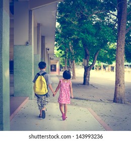 boy and girl walking in the school with holding their hands