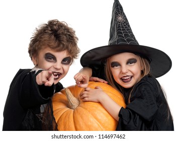 Boy And Girl Wearing Halloween Costume With Pumpkin On White Background