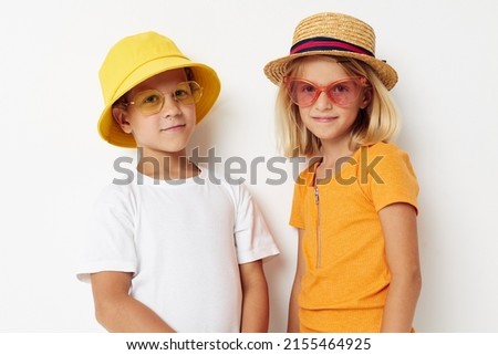 boy and girl wearing hats fashion glasses posing friendship fun