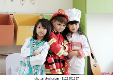 Boy and girls playing as fireman police, doctor and chef occupation in kindergarten class, kid occupation, education concept