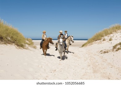 A boy and girls riding horses - Powered by Shutterstock