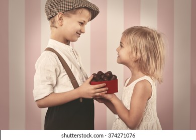 Boy Giving A Girl Box Full Of Chocolates