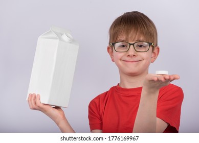 Boy In Glasses Holding Carton Of Milk Or Juice. Copy Space. Template. Mockup.