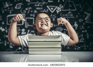 A boy with glasses sitting in the study and with both arms perpendicular