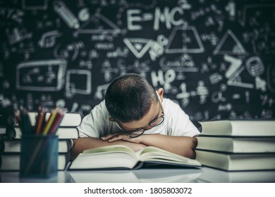 A boy with glasses studying and drowsy.