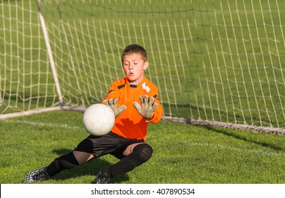 Boy Goalkeeper Defends The Goal