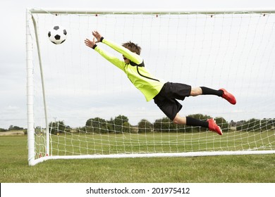 Boy Goalkeeper Jumping To Save Goal