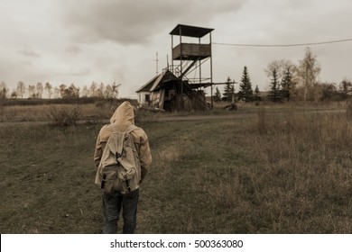 boy goes to an abandoned building. Boy in the field. Post apocalypse. Boy traveling on foot in a post-apocalyptic world in search of food. post-apocalyptic world.