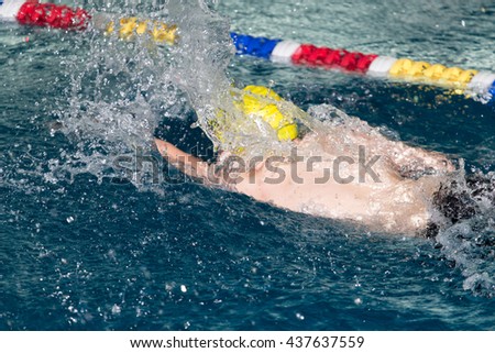 boy goes in for sports in the pool