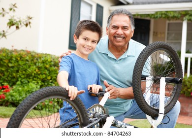 boy and grandfather fixing bike - Powered by Shutterstock