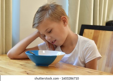 The Boy Grimaced From Food. The Student Doesn't Want To Have Breakfast Cheerios. Poor Appetite In A Child.