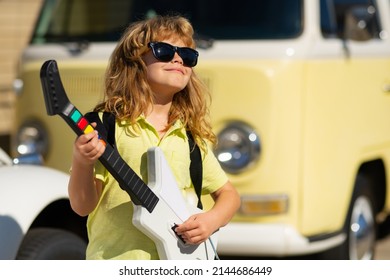 Boy With Guitar. Child Plays A Guitar And Sings, Kids Music And Song. Fashion American Country Boy Playing Music.