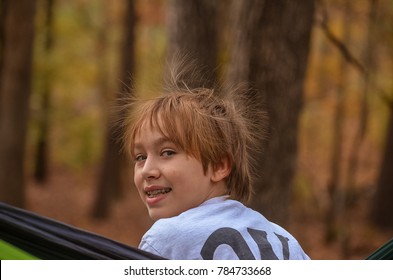 Boy In Hammock With Static Hair In The Fall