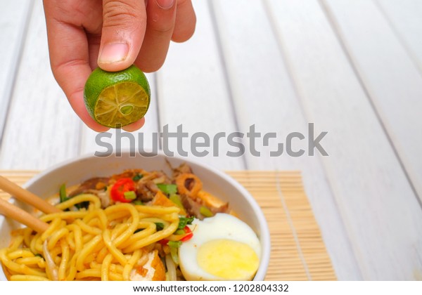 Boy Hand Squeezing Lime On Malay Stock Photo Edit Now 1202804332