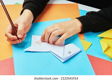 Boy Hands Making Origami Dog With Colorful Paper Sheets, Child Creative Education