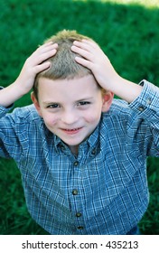 Boy with hands on head