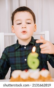 Boy Is Happy And Celebrates His 6th Birthday. Burning Candle In The Form Of The Number 6. Cake With Candle	