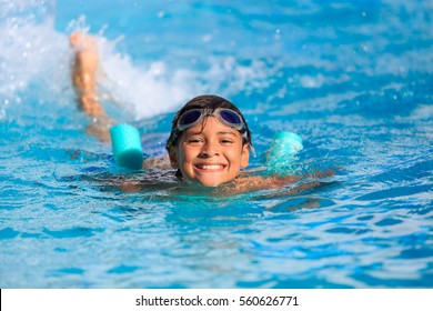Boy happy swimming in a pool 