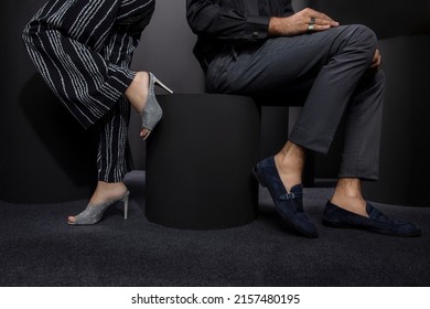 The Boy Has Been Placed On The Shirt Wearing Black Pants And Sat On The Stool, The Color Black Shoe Feet, And The Girl Is Wearing Black Grey Color Of The Dress And The Girl Standing In A Leg Of Stool