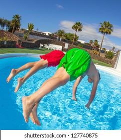 Boy Has Fun Jumping In The Pool