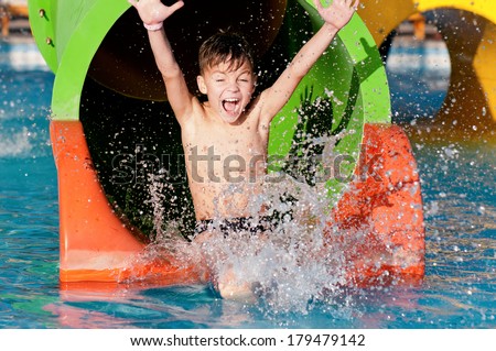 Boy has into pool after going down water slide during summer 
