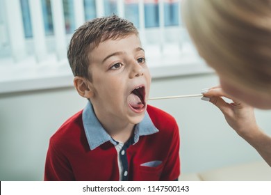 Boy Has Strep Throat. Children's ENT Doctor Examines  Boy's Throat. Children's Diseases, Medical Examination.