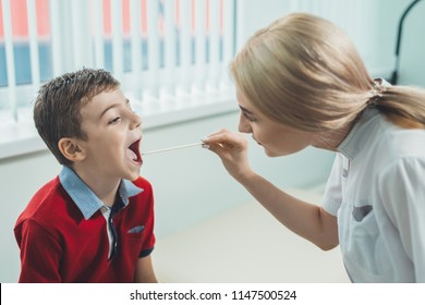 Boy Has Strep Throat. Children's ENT Doctor Examines  Boy's Throat. Children's Diseases, Medical Examination.