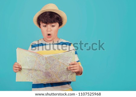 Image, Stock Photo boy with hat and map on blue background