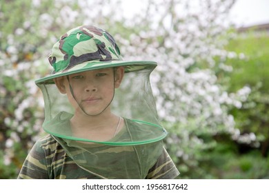 Boy In A Hat With A Mosquito Net