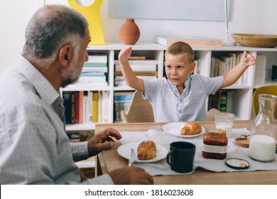 boy having breakfast at home with his grandfather - Powered by Shutterstock