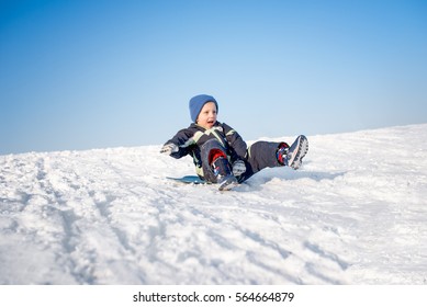 Boy is having fun on snow, sledding - Powered by Shutterstock