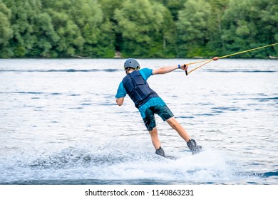 Boy Having Fun With Waterski On The Lake.