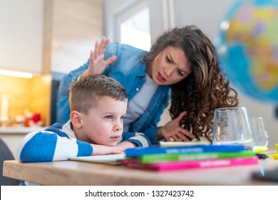 Boy Having Problems In Finishing Homework. Sad Little Boy Turned Away From Mother, Does Not Want To Do Boring Homework. School Problems Concept 