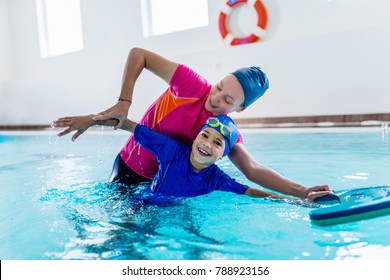 Boy having a swimming lesson with instructor - Shutterstock ID 788923156