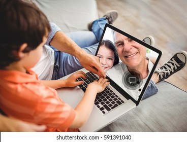 Boy Having A Video Call With Grandfather On Laptop At Home