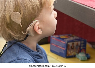 A Boy With A Hearing Aids And Cochlear Implants