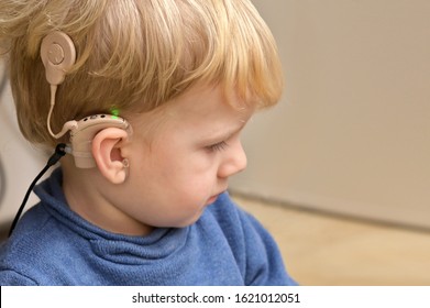 A Boy With A Hearing Aids And Cochlear Implants