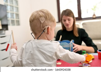 A Boy With A Hearing Aids And Cochlear Implants Playing