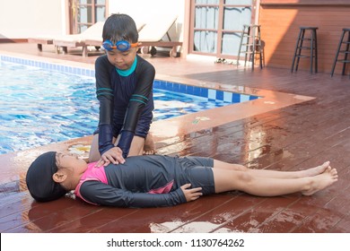 Boy helping drowning child girl in swimming pool by doing CPR. - Powered by Shutterstock