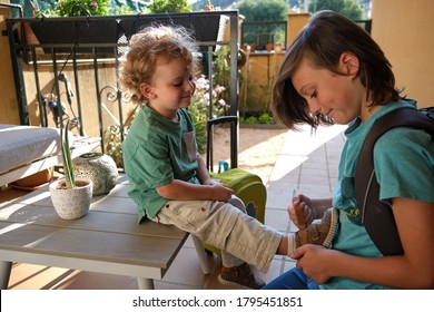 Boy Helping His Brother Tie Shoes Getting Ready For School, Child Buttoning Up Child's Laces, Young Child And Brother Getting Ready For Walk With Parents, Siblings Friendship And Good Relations