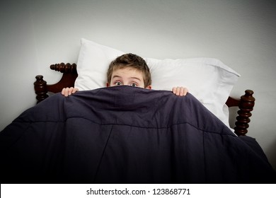 Boy Hiding In Bed Under The Covers