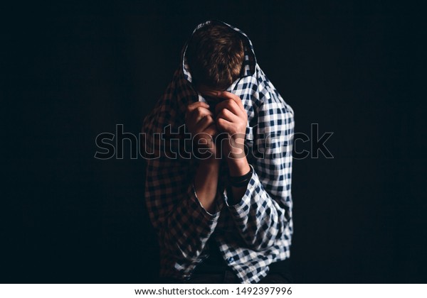 boy hiding his face