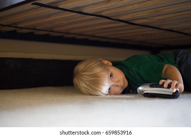 Boy Hiding Under Bed