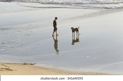 A boy and his dog. Half Moon Bay, California