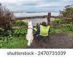 A boy and his dog watching the surf at Kalaloch Beach in Olympic National Park